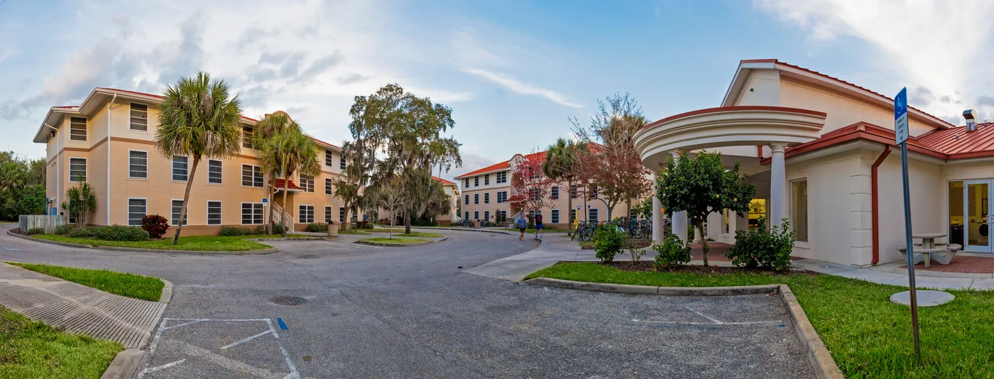 A panoramic view of columbia village showing a group of large stucco apartment buildings
