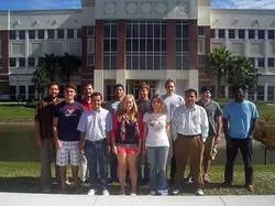 Group from left to right: Back: Alfred Menendez, Marcus Hohlmann, Amilkar Quintero,  Mike Abercrombie, Patrick Ford, Judson (Ben) Locke, Kondo Gnanvo.  Front: Andrea Citati, Samir Guragain, Johanna-Laina Fischer, Xenia Fave,  Himali Kalakhety.