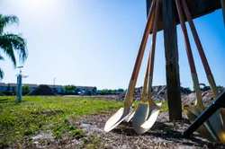 Ceremonial groundbreaking shovels stand ready for use.