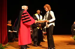 Receiving a handshake after getting her certificate